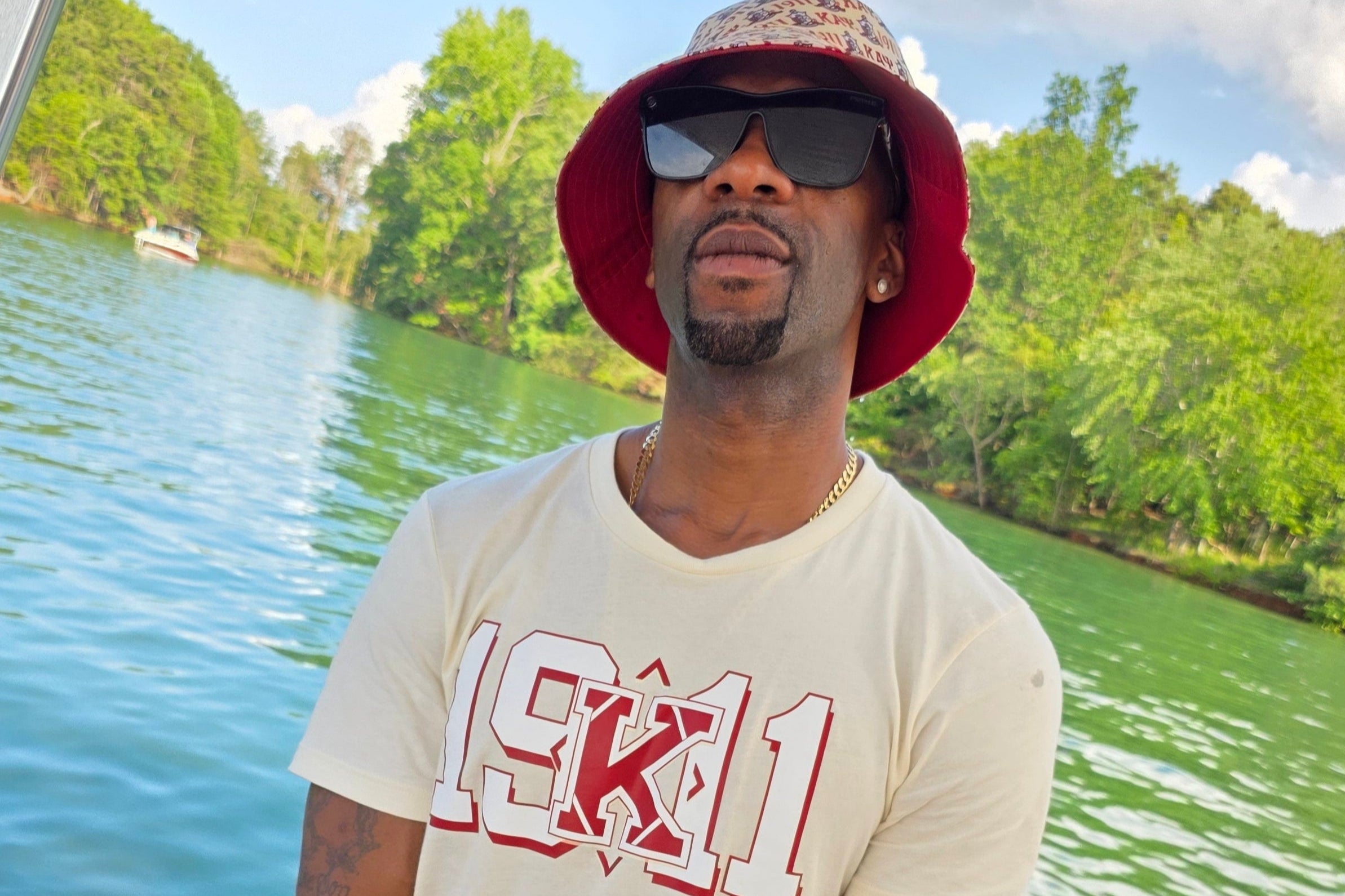 Nupe on a Boat wearing a Kappa Bucket Hat and 191 shirt